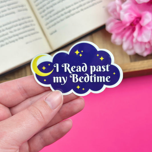 Sticker with 'I Read past my Bedtime' text held by a hand, with flowers and an open book in the background.